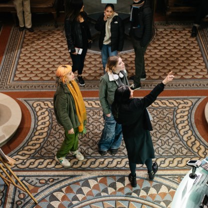 A highlight image for Two visitors speaking to a staff member