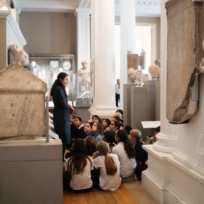 A highlight image for Museum educator teaching a group of young school children