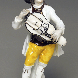 A figurine of a hurdy gurdy player