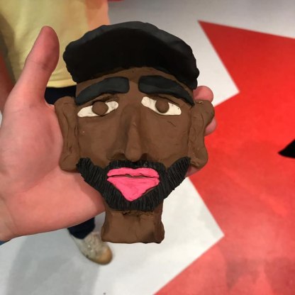 plasticine drawing of the face of a man with a beard and black skin 