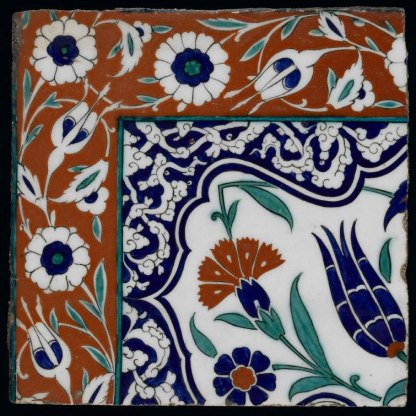 Iznik tile showing a blue tulip, red carnations and pale green serrated saz leaf.