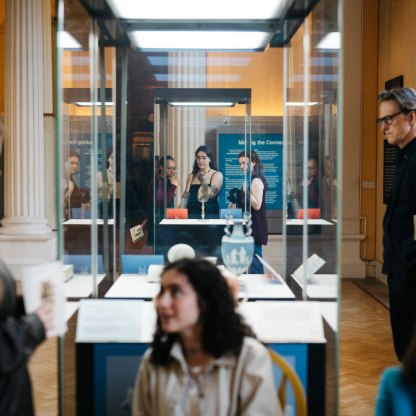 A highlight image for Visitors looking at glass case
