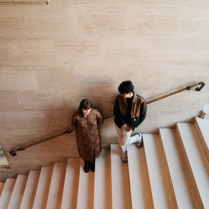 A highlight image for Two figures standing on stairs