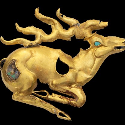 Gold recumbent stag plaque with inlays of turquoise and lapis lazuli