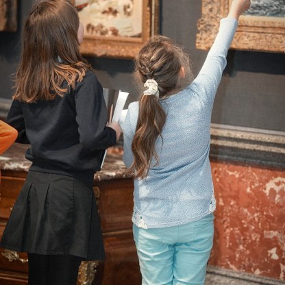 children pointing at a painting in the gallery